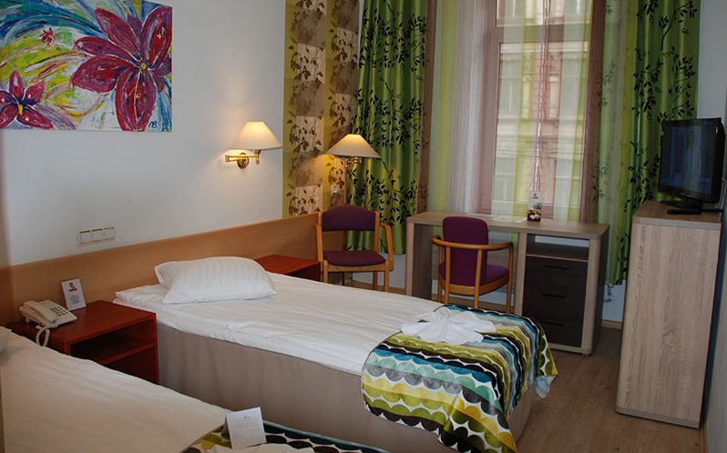 Single room with a colourful bedspread